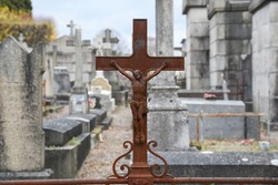 Old Christian crosses and tombs in a cemetery in France.