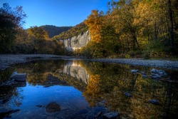Sunset photo during the autumn as the trees change color at Roark Bluff in Steel Creek Campground along the Buffalo River located in the Ozark Mountains, Arkansas. 