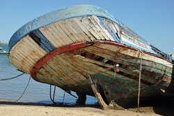 old damaged boat in red white and blue color
