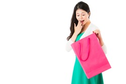 surprised woman looking pink shopping bag on the white wall background over empty  area finding excited thing in the sack on copyspace.