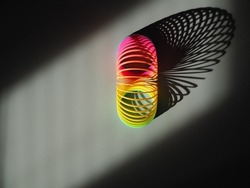 Multicoloured child’s spring toy in sunlight   