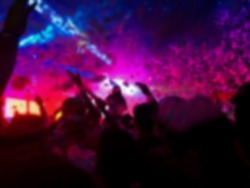 Young happy people are dancing in club. Nightlife and disco concept. Blurred background concept