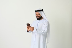 Arab Emirati man texting in UAE using mobile phone and sending or receiving messages maybe making a business call