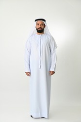 Emirati young man standing in UAE full body wearing traditional dress isolated on white background