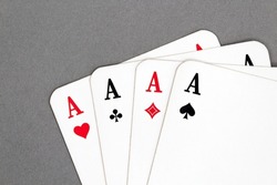 Stack of playing cards four aces isolated on a gray background 