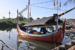 An old fishing boat is moored in the jetty when it is not being used for fishing. The ship is also used to take tourists who will see tours in the sea of ​​Bali