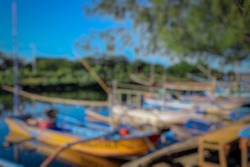 Defocus image background of An old fishing boat is moored in the jetty when it is not being used for fishing. The ship is also used to take tourists who will see tours in the sea of ​​Bali. May day