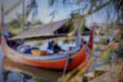 Defocus and blurred image background of fishing boat is moored in the jetty when it is not being used for fishing. The ship is also used to take tourists who will see tours in the sea of ​​Bali