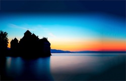 Silhouette of castle on lake at dawn. Castle silhouette at lake dawn. Lake castle at dawn. Sunrise over lake castle