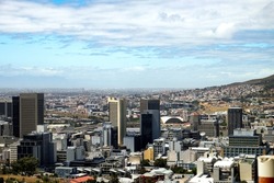 View of Cape Town’s majestic buildings from Signal Hill on a partly cloudy day in the summer.