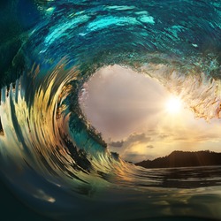 Beautiful ocean surfing wave breaking at sunset beach