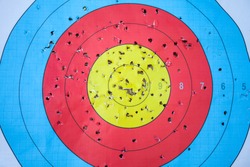 Shooting target and bulls eye with holes, drilled background