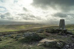 Trig point, near Twice Brewed, on Hadrian's Wall, Northumberland, UK. The area is a UNESCO World Heritage Site.