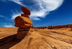 Large hoodoo in foreground of red desert landscape