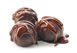 chocolate truffle balls with melted chocolate macro isolated on a white background