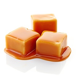 caramel candies and caramel sauce isolated on a white background