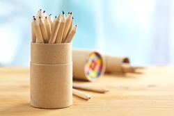 Colored pencils in pencil case on wooden table, selective focus