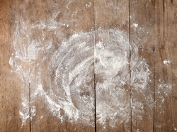 white flour on rustic wooden table, top view