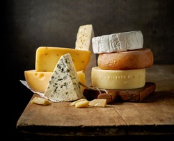 various types of cheese on rustic wooden table
