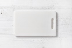 white plastic cutting board on table, top view