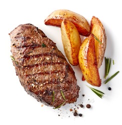 grilled beef steak and potatoes isolated on white background, top view