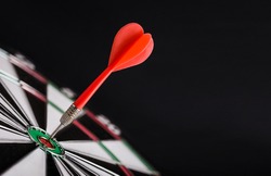 Red dart arrow on center of dartboard. Concept o business target, success and win.