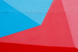 Colorful (blue, red and pink) painted wall with cracks as background or texture