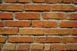 Fragment of a ceramic brick wall with white masonry mortar, white masonry seams, close-up.