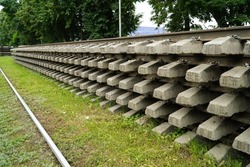 Old rails and sleepers. The rails and sleepers are stacked on each other. Renovation of the railway. Rail road for the train.