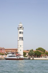 Lighthouse and Venice waterbus Vaparetto at Isle of Murano, Venice, Italy