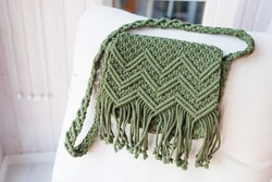 Handmade macrame bag dark green color. ECO friendly natural macrame cotton cross-body bag. Hobby knitting handmade macrame. Modern summer concept. 