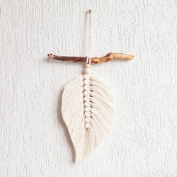Macrame leaf wall hanging in natural color on the wooden stick. Cotton rope decor macrame to make your room more cozy and unique. Copy space