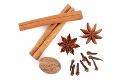 Cinnamon sticks with star anise, nutmeg and clove isolated on white background. Top view