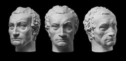 Three gypsum copy of ancient statue Gattamelata, Erasmo di Narni, head isolated on black background. Plaster sculpture man face.