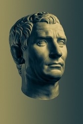 Bronze color gypsum copy of ancient statue of Guy Julius Caesar Octavian Augustus head for artists isolated on brass background. Renaissance epoch. Plaster sculpture man face.Template for art design