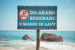 No swimming and bathing in the sea, a prohibition board for visitors at the marina beach, Kalianda sub-district, South Lampung.