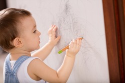 Baby drawing on wall.
