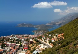 Panoramic views of the Mediterranean coast, mountains and clouds, silhouetted to resemble the islands below, near the town of Kaş, Antalya region, Turkey