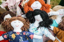 colorful sewed handmade dolls on a fair