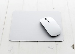 White wireless mouse on a mouse pad