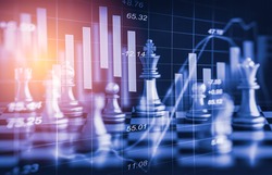 Chess game on chess board behind forex chart indicators or stock market graph in abstract background. Business concept to present financial information and digital marketing strategy analysis.
