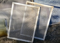 old window frames with mosquito nets.