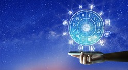 Astrological zodiac signs inside of horoscope circle on Mobile Technology. Astrology, knowledge of stars in the sky over the milky way and moon. Zodiac internet online concept.