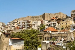 Panoramic view of the urbanization of Tripoli in North of Lebanon, showing mix of types of the Lebanese architecture , at the top of the hill located Qalaat Sanjil  Citadel of Raymond de Saint Gilles
