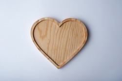 Heart shape wooden tray on white background      