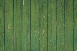 Vertical green vintage weathered textured paint chipped wood panel wall for background texture in any abstract scene