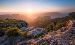 A horizontal photograph of a beautiful sunset over the Blyde River Canyon taken from Mariepskop