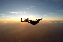 Skydivers having fun at the amazing sunset