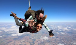 Tandem parachute jump. Beautiful Brazilian woman.