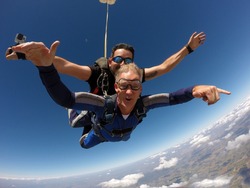 Skydiving tandem happiness middle aged man
